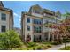 Charming multi-story townhome with red front door and well-manicured landscaping at 323 Concord St, Alpharetta, GA 30009