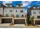 Modern townhome exterior with attached garages and a charming balcony on the second level at 323 Concord St, Alpharetta, GA 30009