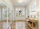 Bright foyer with hardwood floors, complemented by a console table and a full mirrored closet at 323 Concord St, Alpharetta, GA 30009
