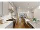 A kitchen showcases a gray island with marble countertops and stainless steel appliances at 323 Concord St, Alpharetta, GA 30009