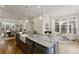 Spacious kitchen with a gray island, marble countertop, sink, and hardwood floors at 323 Concord St, Alpharetta, GA 30009