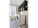 Modern laundry room with dark cabinets, a side-by-side washer and dryer, and patterned flooring at 323 Concord St, Alpharetta, GA 30009