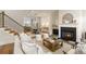 Open-concept living area with a fireplace, staircase, hardwood floors, and sightlines to the dining area at 323 Concord St, Alpharetta, GA 30009