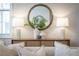 Tastefully decorated living room featuring a woven sideboard, mirror, and two lamps at 323 Concord St, Alpharetta, GA 30009