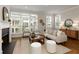 Bright living room with fireplace, large windows, and hardwood floors at 323 Concord St, Alpharetta, GA 30009