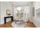 Bright sitting area featuring modern chandelier, large windows, hardwood floors, and neutral decor at 323 Concord St, Alpharetta, GA 30009