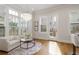 Bright sitting area with hardwood floors, pendant light, white armchairs and access to the back patio at 323 Concord St, Alpharetta, GA 30009