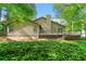The back exterior of the house features a deck and mature trees at 5245 Olde Mill Rd, Woodstock, GA 30188
