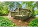Back exterior of the home with a deck and lush landscaping at 5245 Olde Mill Rd, Woodstock, GA 30188