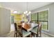 An open concept dining room featuring a wooden table set under a chandelier with views into the kitchen at 5245 Olde Mill Rd, Woodstock, GA 30188