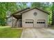 Spacious two-car garage with convenient access and charming exterior details at 5245 Olde Mill Rd, Woodstock, GA 30188