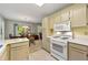 A well-lit kitchen with a view of the dining area, equipped with white appliances at 5245 Olde Mill Rd, Woodstock, GA 30188