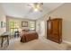 A spacious main bedroom with dual windows, an armoire, and neutral carpeting at 5245 Olde Mill Rd, Woodstock, GA 30188