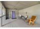 Covered front porch featuring ample seating and a stylish purple door at 5245 Olde Mill Rd, Woodstock, GA 30188