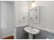 Powder room featuring hardwood flooring, a sink with vanity, and half wall trim at 6213 Indian Wood Cir, Mableton, GA 30126