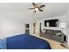 Bright bedroom with ceiling fan, seating area, and a doorway leading to the bathroom at 6213 Indian Wood Cir, Mableton, GA 30126