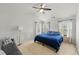 Spacious bedroom featuring a ceiling fan, seating area, and ample natural light at 6213 Indian Wood Cir, Mableton, GA 30126