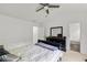 Cozy bedroom featuring stylish furnishings, a ceiling fan, and paneled walls at 6213 Indian Wood Cir, Mableton, GA 30126