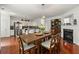 Elegant dining area with hardwood floors, fireplace, and an open-concept kitchen view at 6213 Indian Wood Cir, Mableton, GA 30126
