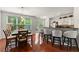 Open dining area with hardwood floors, large windows, and a modern breakfast bar area at 6213 Indian Wood Cir, Mableton, GA 30126
