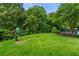 Well-maintained community dog park with lush green grass and convenient waste disposal station at 6213 Indian Wood Cir, Mableton, GA 30126