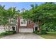 Charming two-story red brick home with attached two-car garage and mature landscaping at 6213 Indian Wood Cir, Mableton, GA 30126