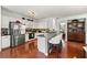 Open kitchen with stainless steel appliances, white cabinets, and breakfast bar seating at 6213 Indian Wood Cir, Mableton, GA 30126