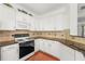 Well-lit kitchen featuring white cabinets, granite countertops, and stainless steel appliances at 6213 Indian Wood Cir, Mableton, GA 30126