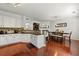 Bright kitchen with white cabinetry, hardwood floors, and open layout with dining area at 6213 Indian Wood Cir, Mableton, GA 30126
