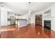 Open-concept living area with hardwood floors, a fireplace, and a view of the kitchen at 6213 Indian Wood Cir, Mableton, GA 30126