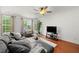 Cozy living room with natural light, hardwood flooring, and comfortable seating arrangement at 6213 Indian Wood Cir, Mableton, GA 30126