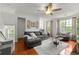 Bright living room with hardwood floors, large windows, and comfortable seating at 6213 Indian Wood Cir, Mableton, GA 30126
