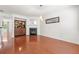 Living room with fireplace, hardwood floors, and a view of the adjoining room at 6213 Indian Wood Cir, Mableton, GA 30126
