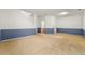 Expansive living room featuring neutral carpet and blue and white walls at 6213 Indian Wood Cir, Mableton, GA 30126