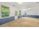 Living room with carpet, blue and white walls, and natural light from several windows at 6213 Indian Wood Cir, Mableton, GA 30126