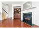 Living room showcasing a fireplace, hardwood floors, and access to the upper level at 6213 Indian Wood Cir, Mableton, GA 30126