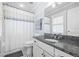 Clean bathroom featuring granite counters, a shower curtain, and tiled floors at 630 John Wesley Dobbs Ne Ave, Atlanta, GA 30312