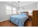 Comfortable bedroom with a blue comforter, hardwood floors, and bedside tables at 630 John Wesley Dobbs Ne Ave, Atlanta, GA 30312