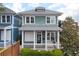 Charming two-story home featuring a welcoming front porch and light-green siding and trimmed with white at 630 John Wesley Dobbs Ne Ave, Atlanta, GA 30312