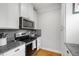 Modern kitchen with stainless steel appliances, granite countertops, and sleek white cabinetry at 630 John Wesley Dobbs Ne Ave, Atlanta, GA 30312
