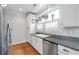 Efficient kitchen showcasing white cabinetry, stainless steel appliances, and granite countertops at 630 John Wesley Dobbs Ne Ave, Atlanta, GA 30312