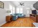 Comfortable living room featuring hardwood floors, a TV, and natural light from the shutters at 630 John Wesley Dobbs Ne Ave, Atlanta, GA 30312