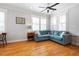 Bright living room with hardwood floors, a ceiling fan, and a comfortable teal sofa at 630 John Wesley Dobbs Ne Ave, Atlanta, GA 30312
