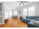 Bright living room featuring hardwood floors, large windows, and a comfortable blue sofa at 630 John Wesley Dobbs Ne Ave, Atlanta, GA 30312