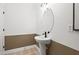 Powder room features a modern sink and simple, minimalist design at 707 Mirror Lake Parkway Way, Villa Rica, GA 30180