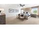 Bright bedroom with a ceiling fan, neutral decor, and large bed flanked by matching bedside tables at 707 Mirror Lake Parkway Way, Villa Rica, GA 30180