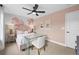 Pink floral bedroom design featuring a glass desk, accent wall, and matching bedside tables at 707 Mirror Lake Parkway Way, Villa Rica, GA 30180
