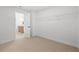 Empty bedroom with neutral carpet and a closet, with a partial view of the bathroom at 707 Mirror Lake Parkway Way, Villa Rica, GA 30180