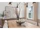 A beautifully decorated dining table features a stylish centerpiece with artwork nearby at 707 Mirror Lake Parkway Way, Villa Rica, GA 30180