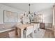 Beautiful dining room with a modern chandelier, large table and seating for six at 707 Mirror Lake Parkway Way, Villa Rica, GA 30180